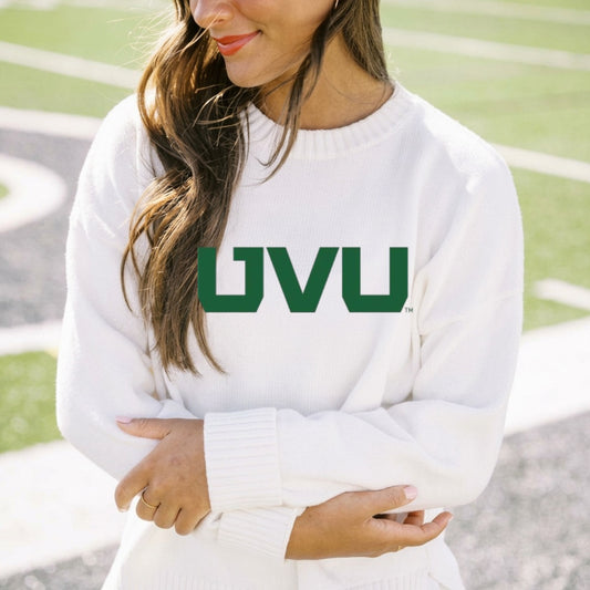 Person wearing a white sweater with 'UVU' printed on it, standing outdoors.