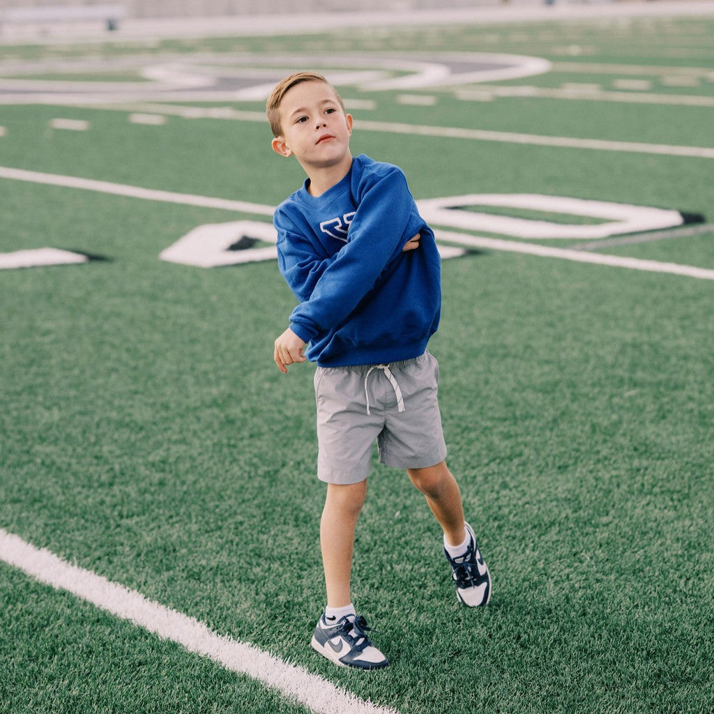Boy on football field throwing a ball