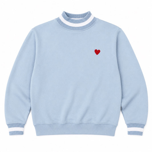 Light blue sweater with a red heart on a white background