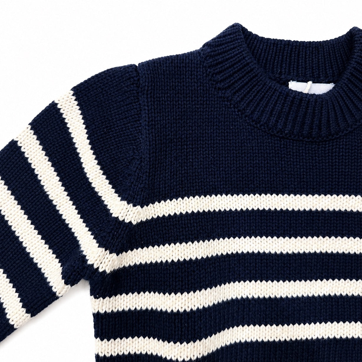 Navy and white striped sweater on a white background